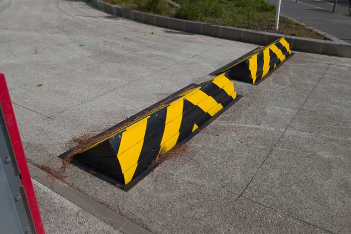 Two raisable road blockers black yellow for preventing of cars enter