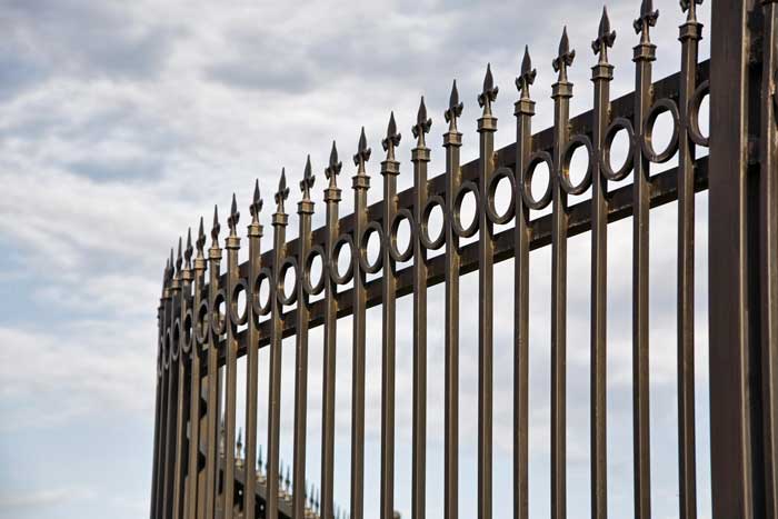 Curved metal fence with spikes

